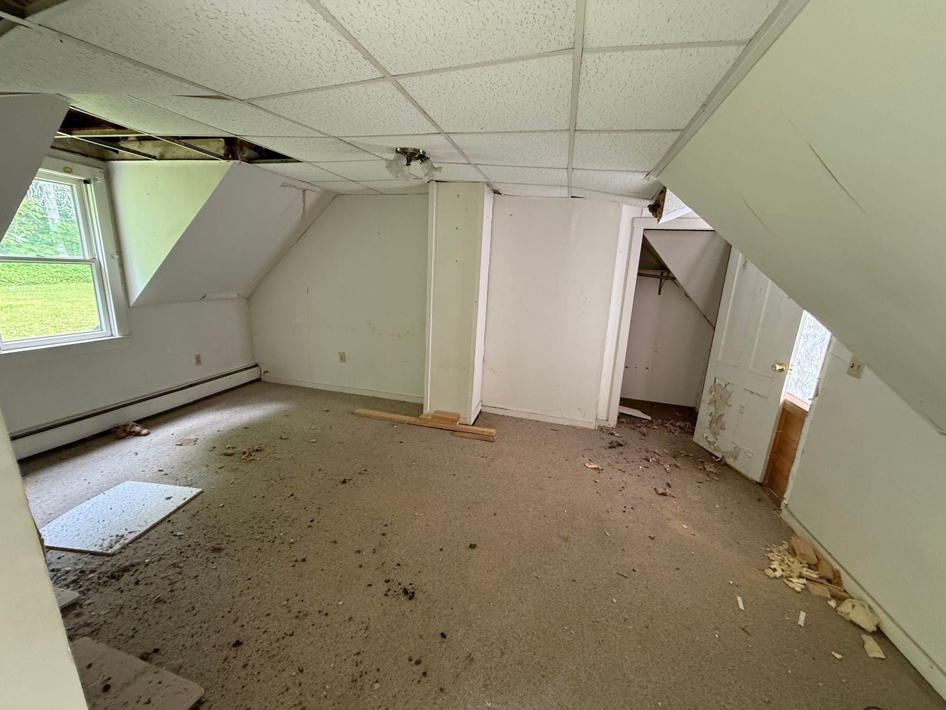 Empty, attic room with slanted ceiling