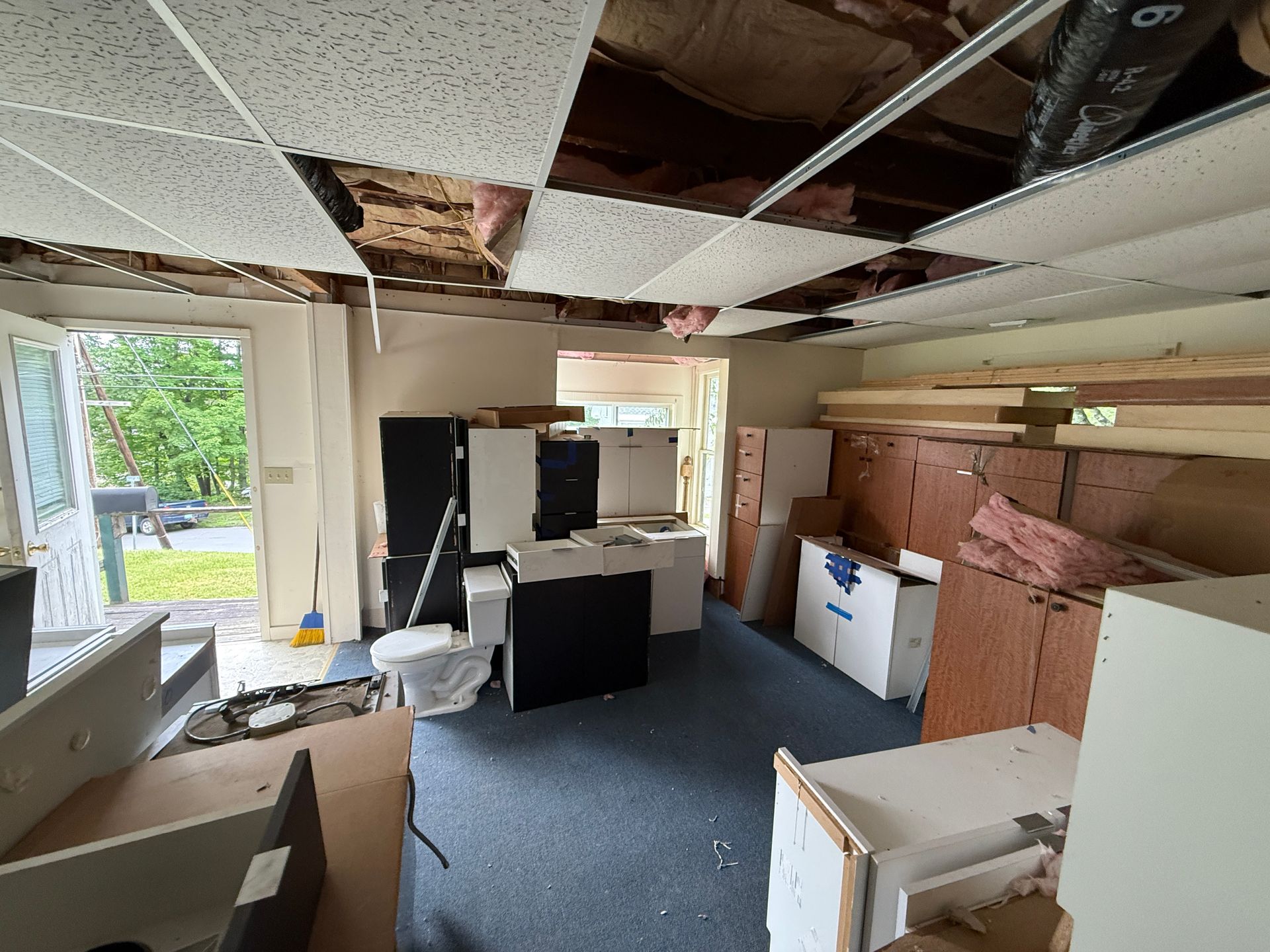 office interior with ceiling tiles, exposed beams