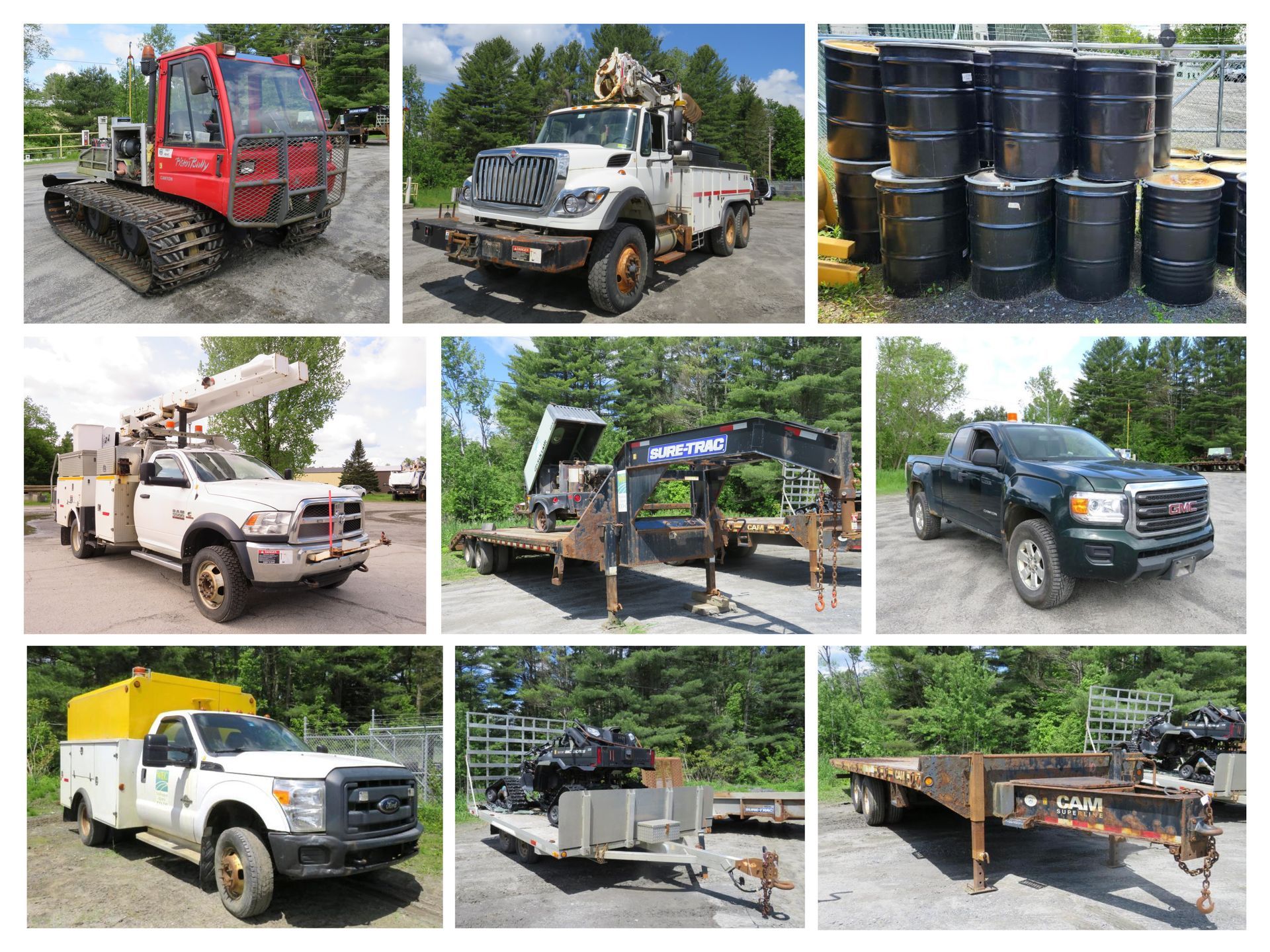 Collection of work trucks, trailers, and barrels outdoors.