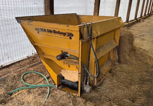 Yellow farm feed hopper/bin.