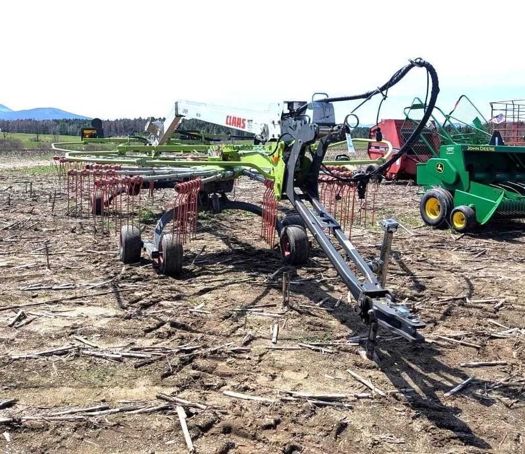 Green farm machinery working in a field.