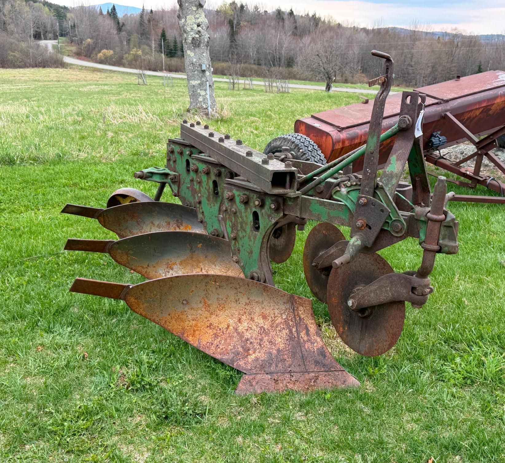 Vintage plow attachment in a grassy field