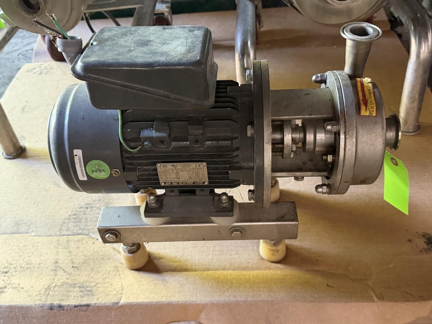 Industrial electric motor and pump assembly mounted on a metal base with a green tag