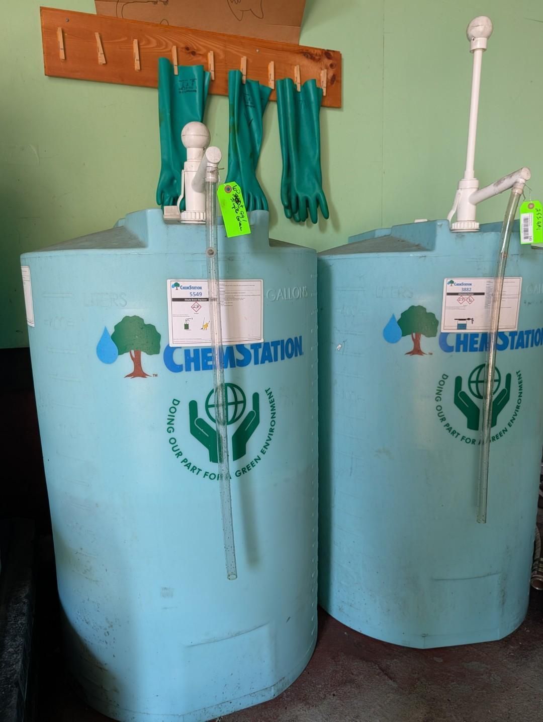 Two blue handwashing stations with taps and towels hanging on a wall rack