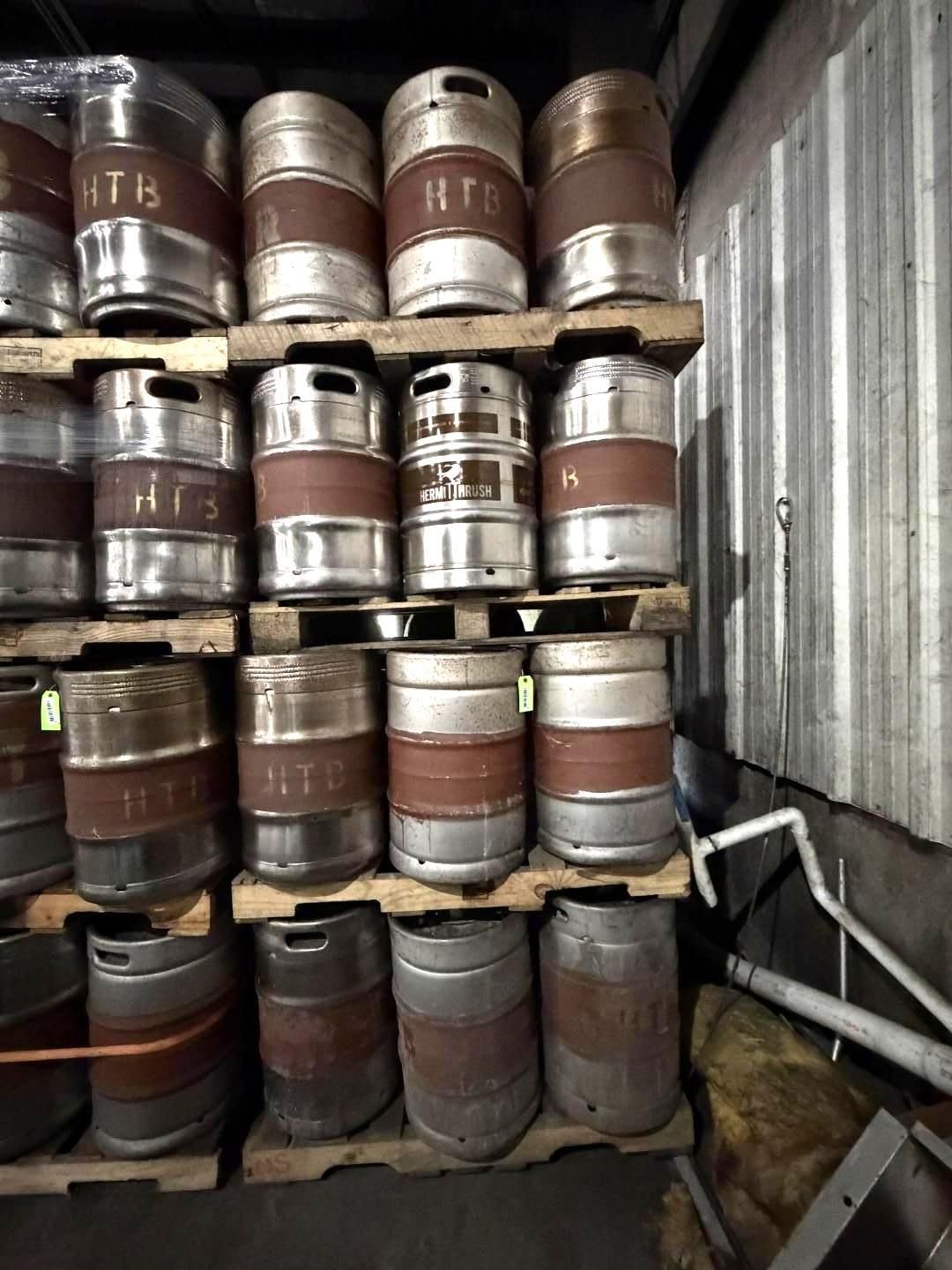 Stacked metal barrels stored in a shed