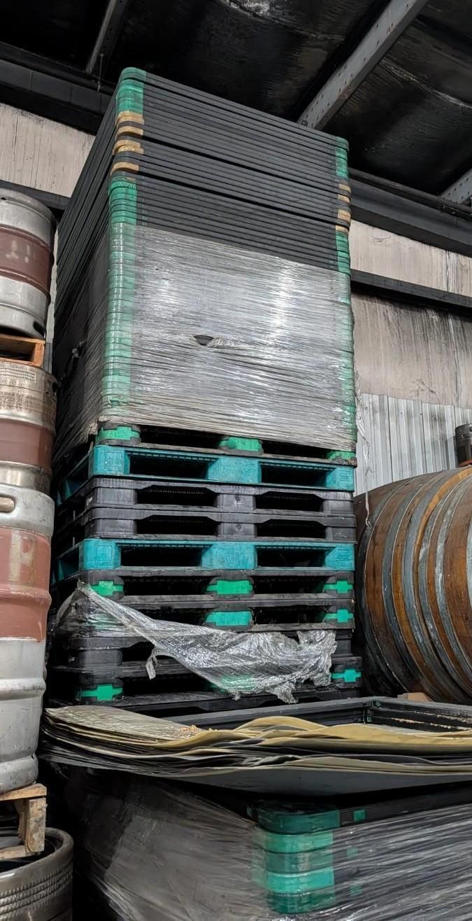 Stacked industrial pallets wrapped in plastic