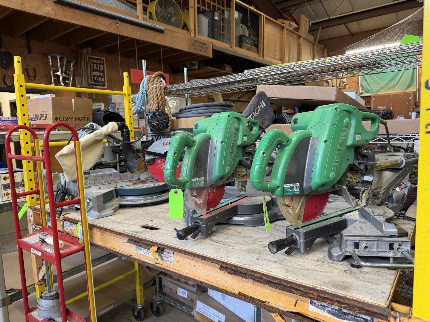 Workshop workbench with two green machine parts and tools