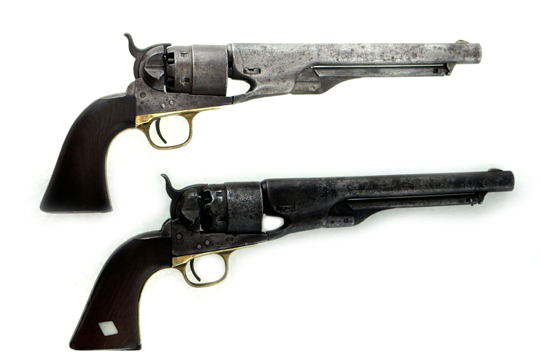 Two antique Colt Paterson revolvers, top one is lighter colored than bottom.
