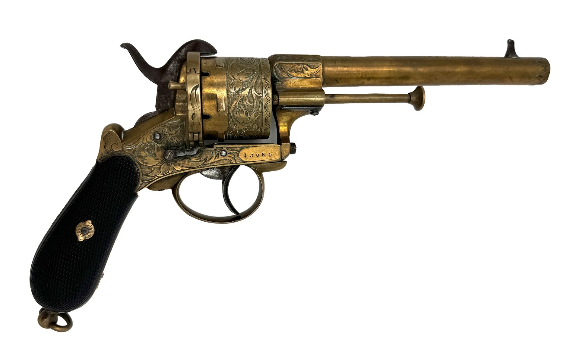 Ornate brass revolver with black grip, likely antique.
