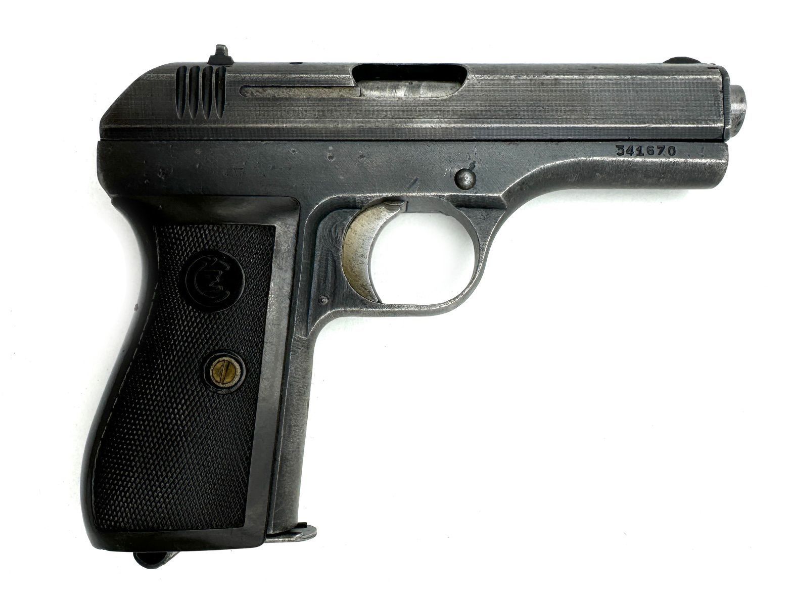 Dark, metallic handgun with textured grip, serial number visible.