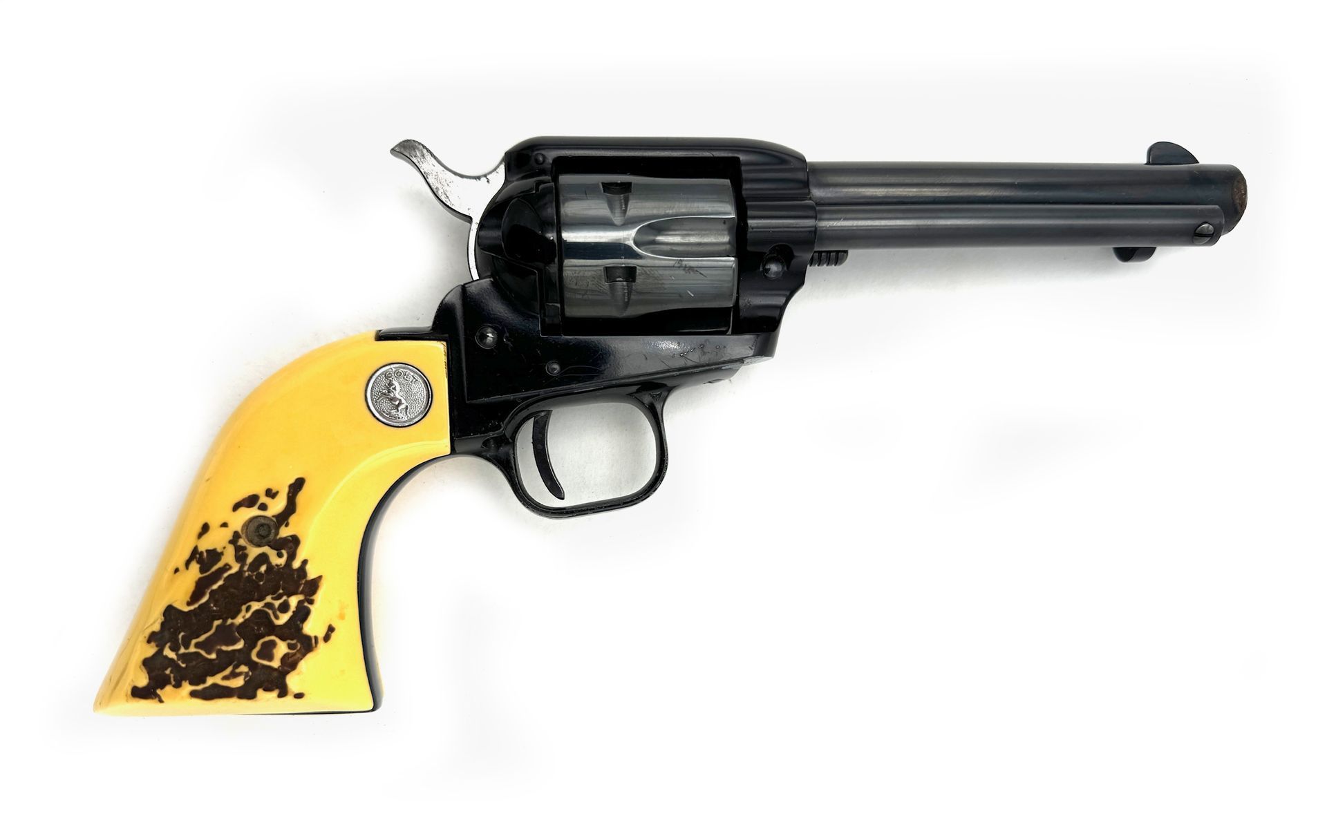 Black and yellow revolver with a long barrel, white background.