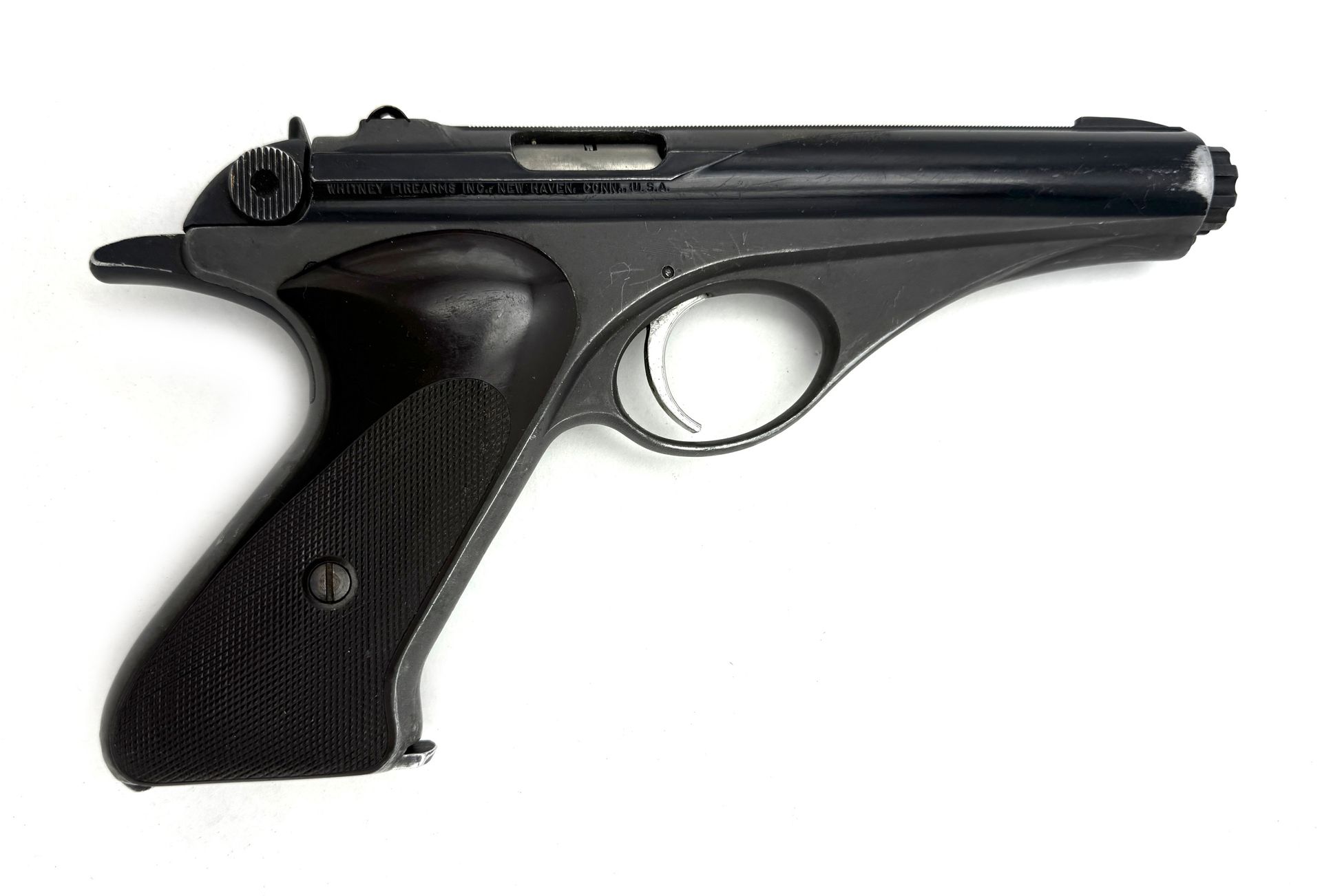 Black, bolt-action pistol with wooden grip, against a white background.