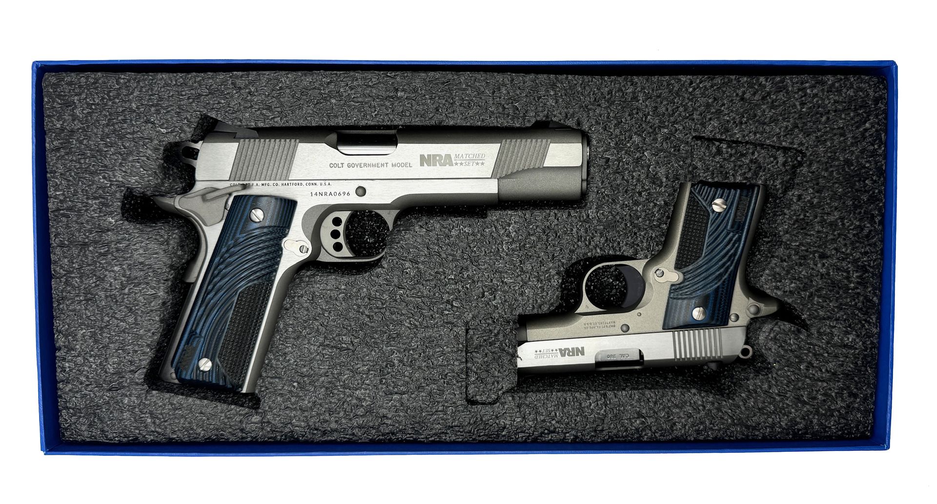 A silver handgun and its parts in a foam-lined box.
