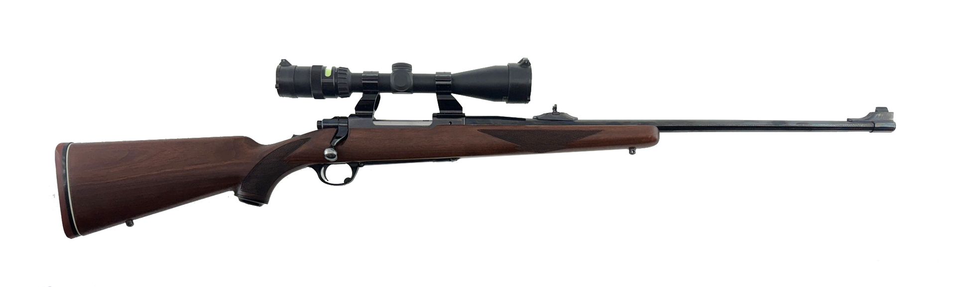 A hunting rifle with a scope, featuring a dark wooden stock and metal barrel.