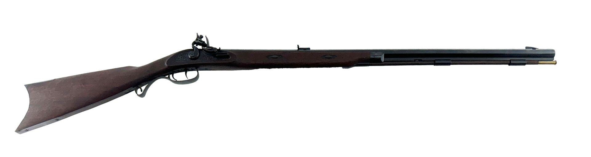 A long, brown, antique rifle with a dark barrel. It is resting on a white surface.