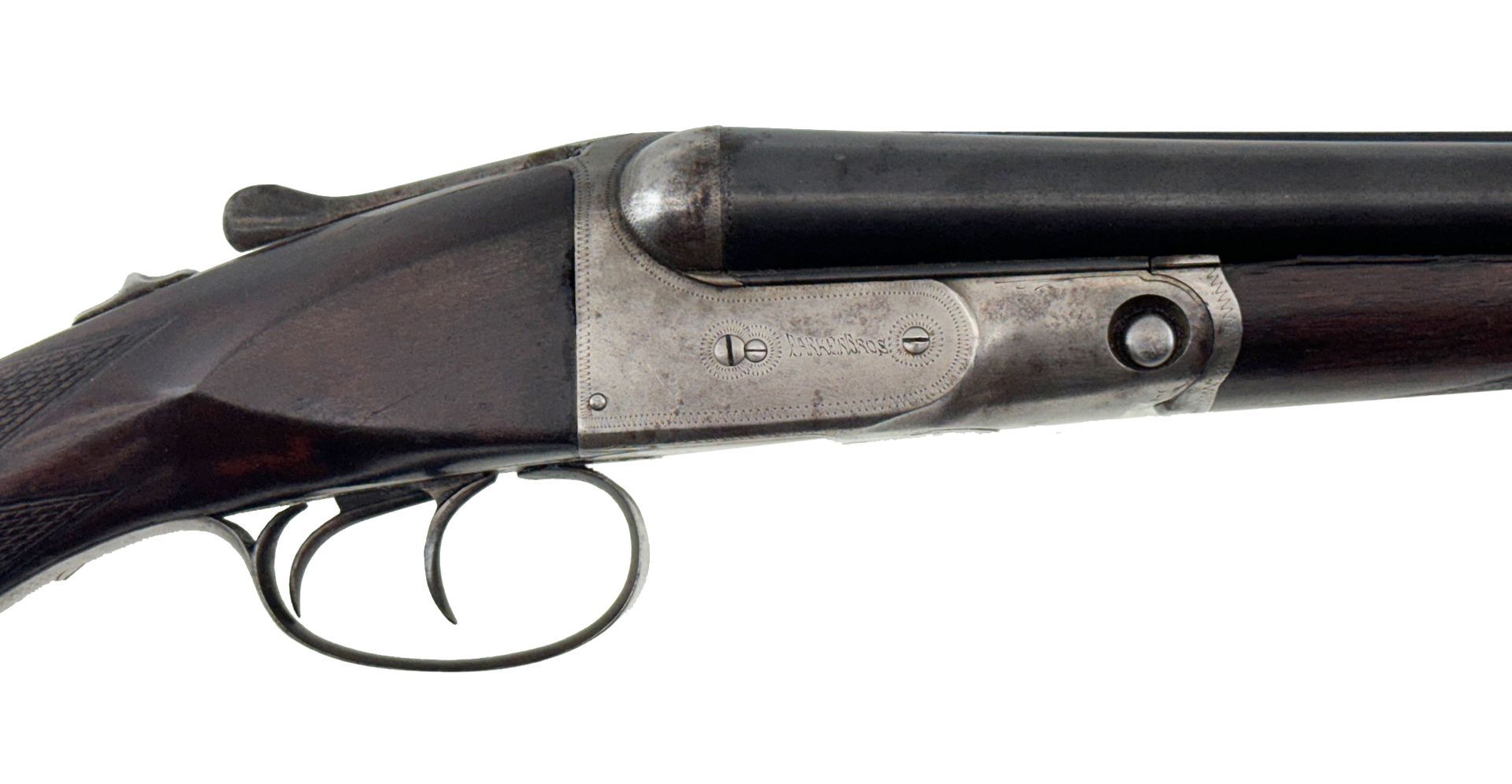 Side view of a double-barreled shotgun, brown wood stock and fore-end, black barrels, and silver receiver.