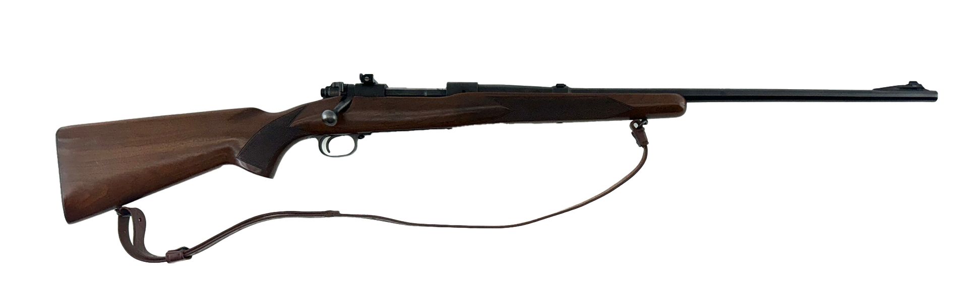 A brown rifle with a dark barrel and wooden stock, with a sling attached.