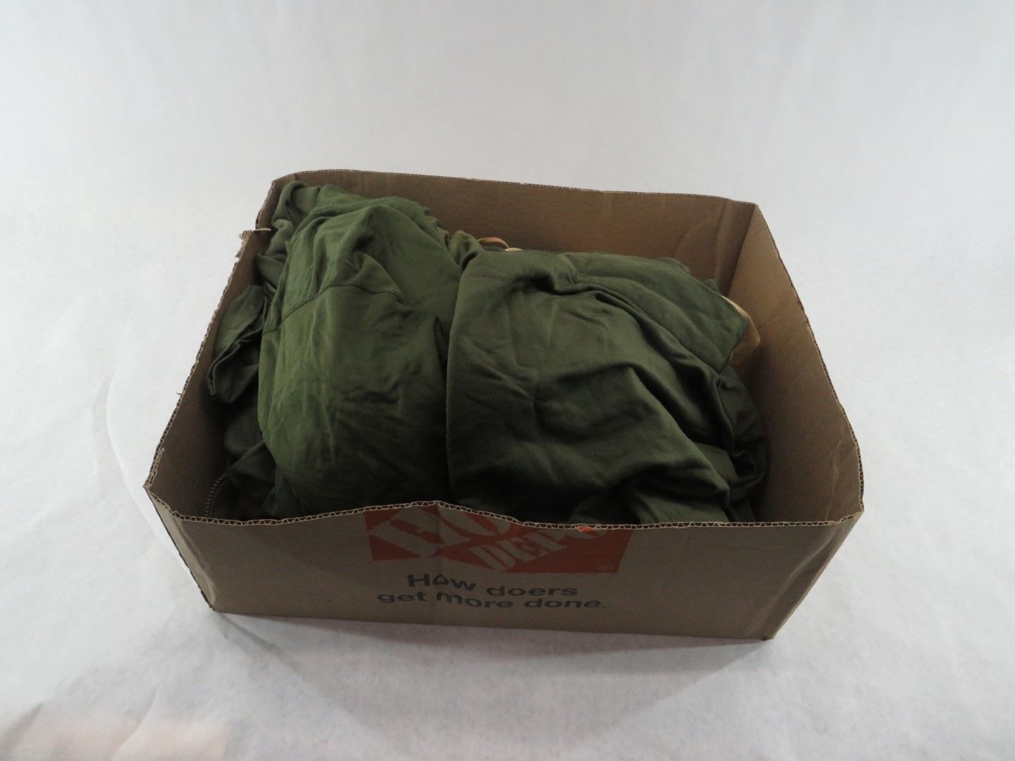 Green fabric in a cardboard box.