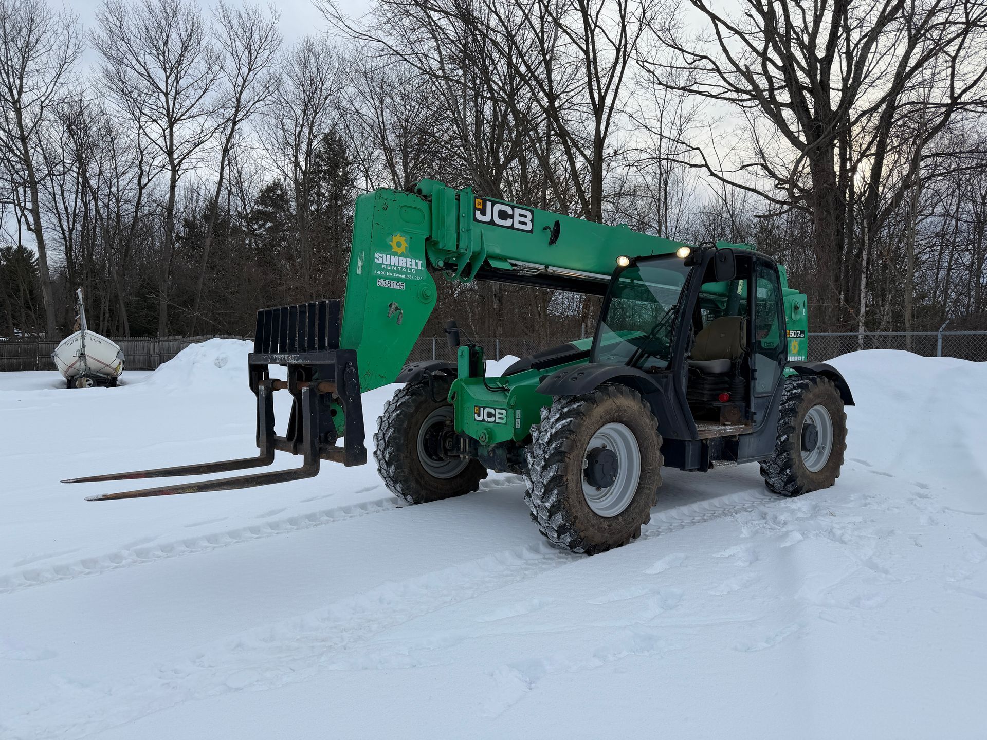 Green telehandler with forks