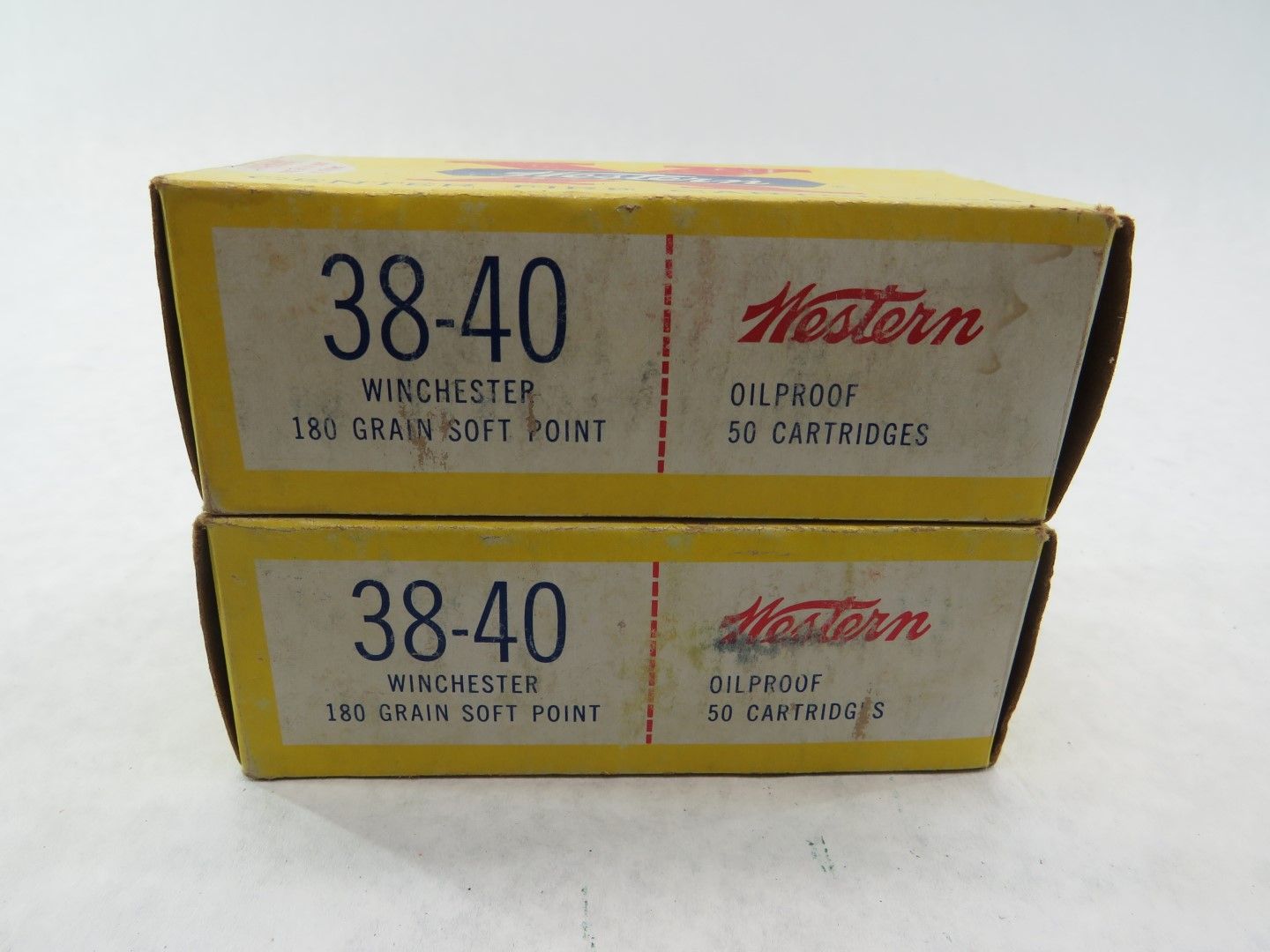 Two yellow boxes of Winchester 38-40 ammunition with red 