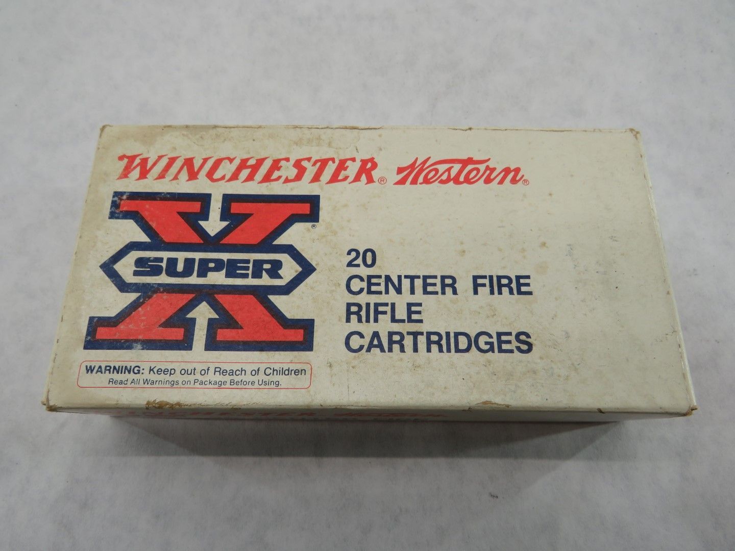 Box of Winchester Super X rifle cartridges with red and blue logo.