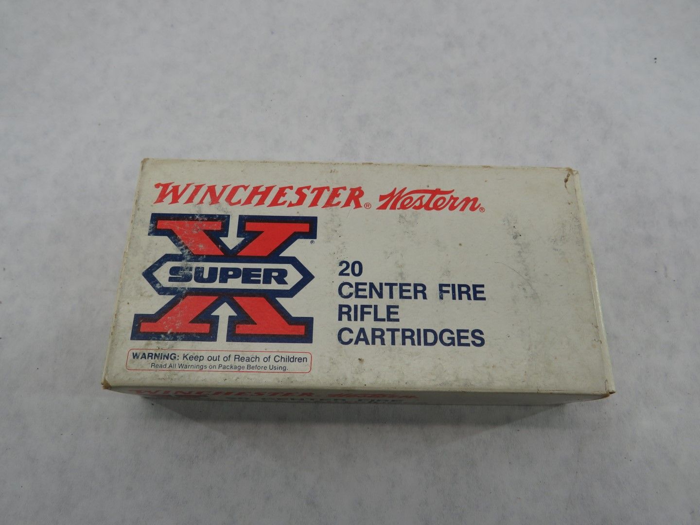 Box of Winchester Super X rifle cartridges, white with red and blue logo, 