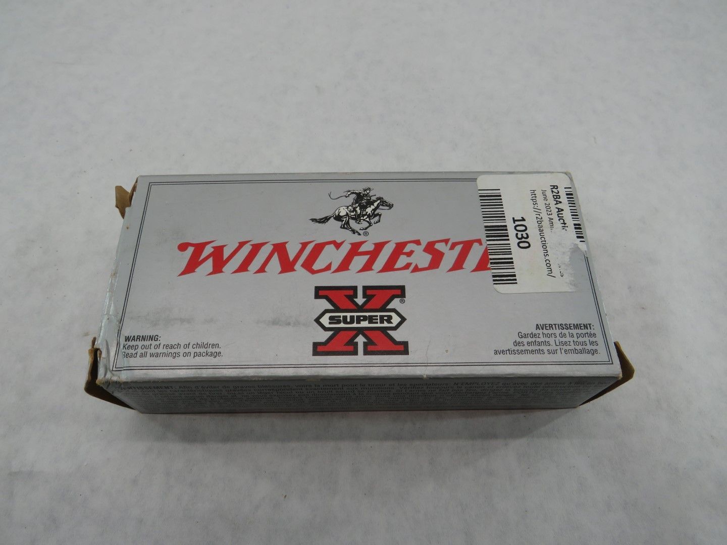 Box of Winchester Super X ammunition. Silver box with red text and logo.