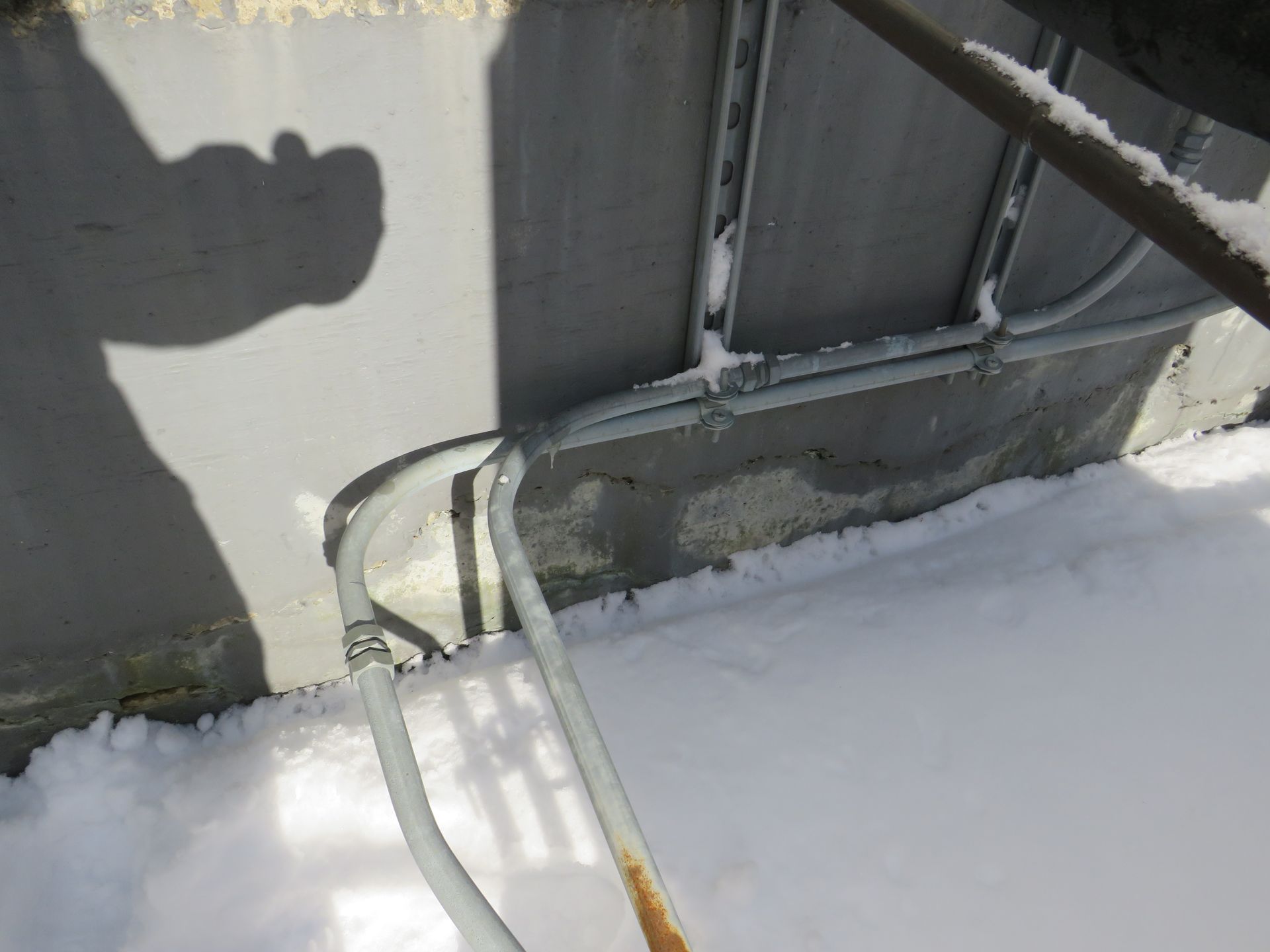 electrical conduit leading inside a building.