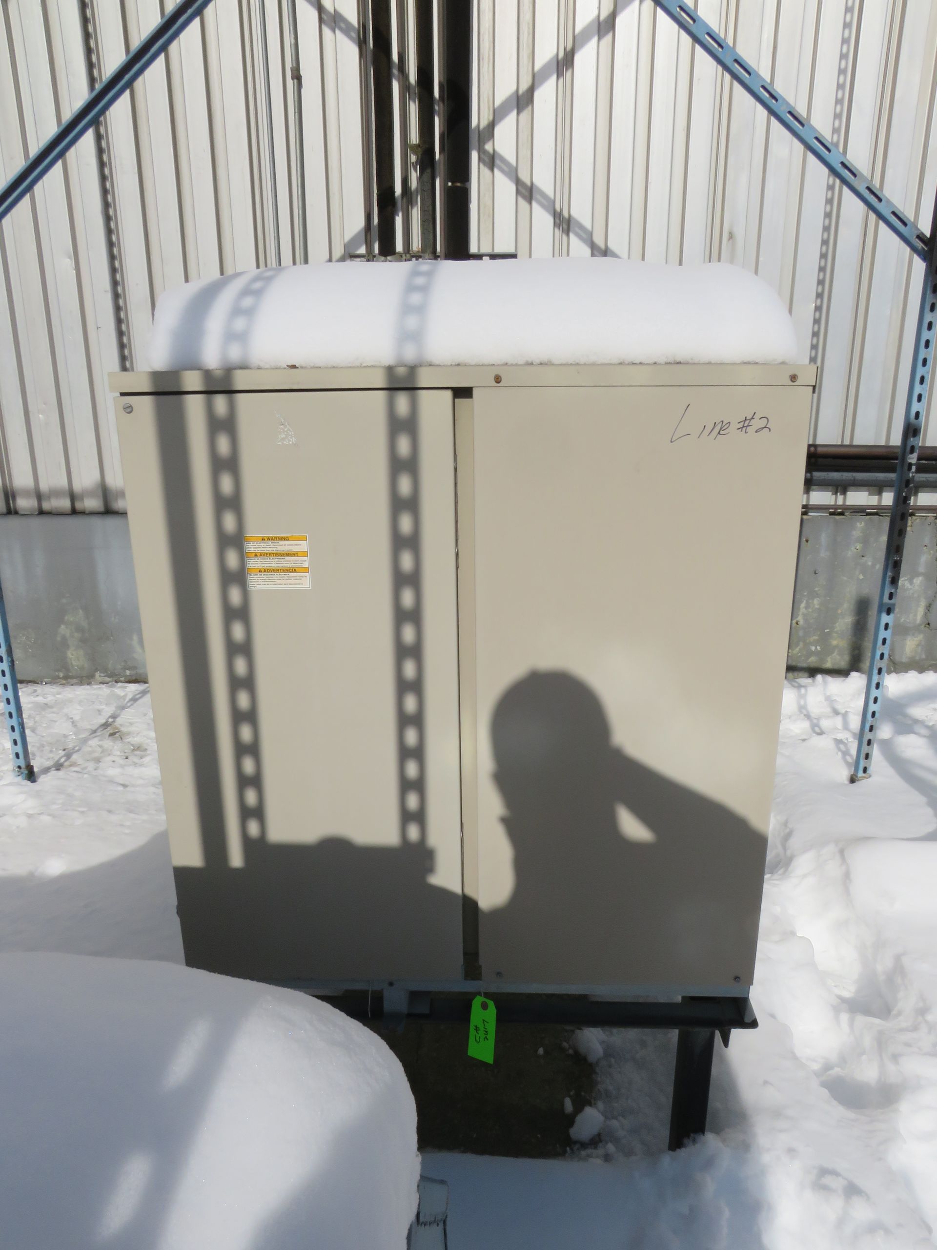 Outdoor electrical cabinet covered in snow.