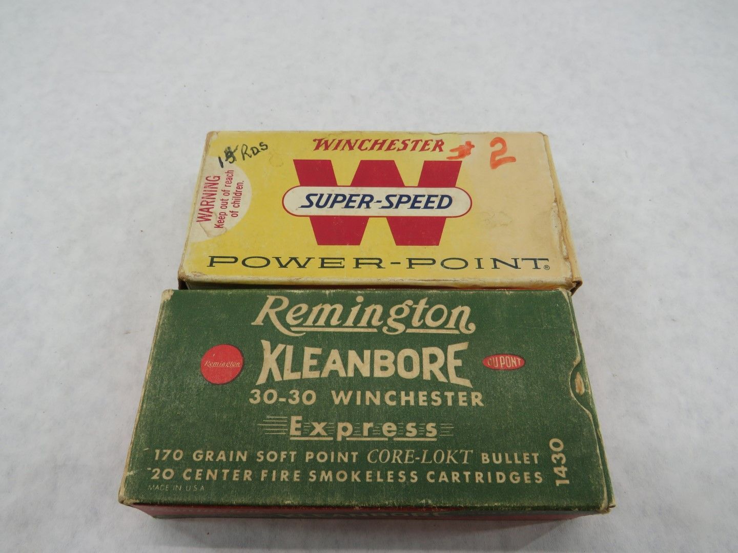 Two boxes of ammunition: Winchester Super-Speed Power-Point (yellow) and Remington Kleanbore Express (green).