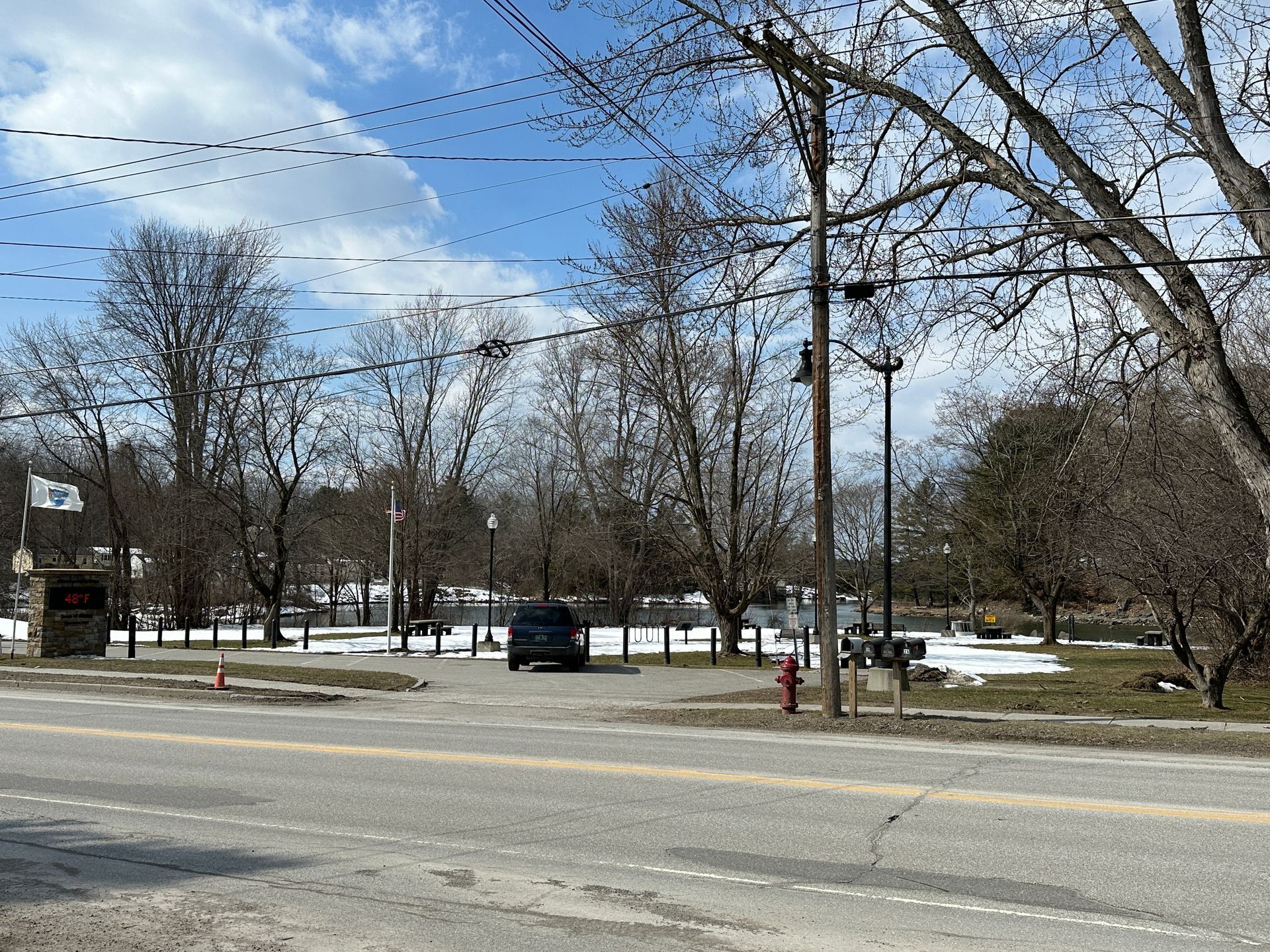 A gravel parking area sits off a road.