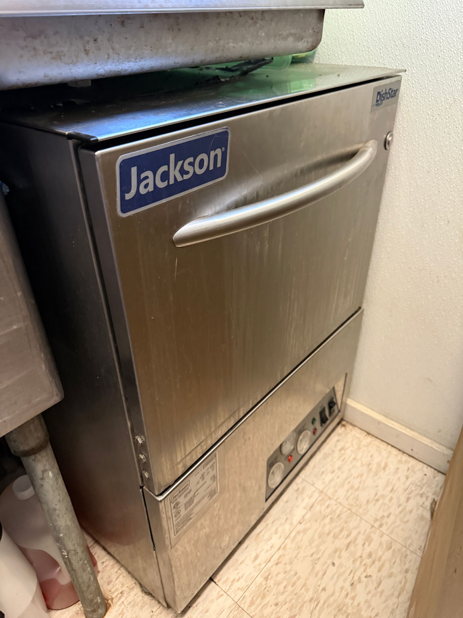 Stainless steel Jackson commercial dishwasher in a kitchen setting.