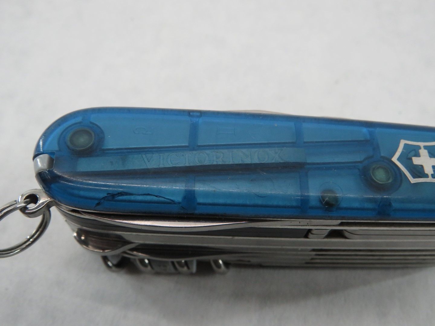 Blue Swiss Army knife with visible tools and a keychain ring.