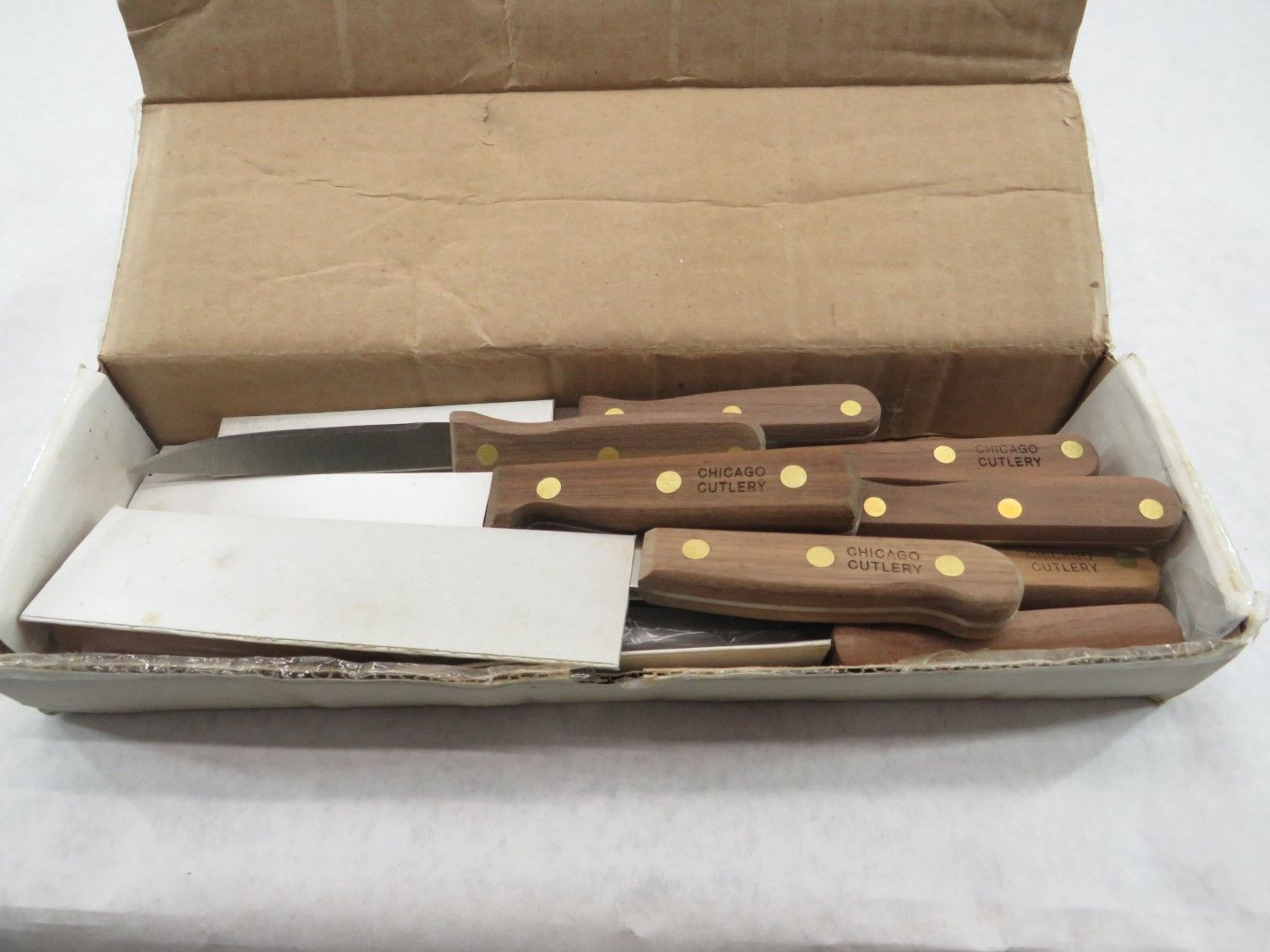Box of knives with wooden handles.