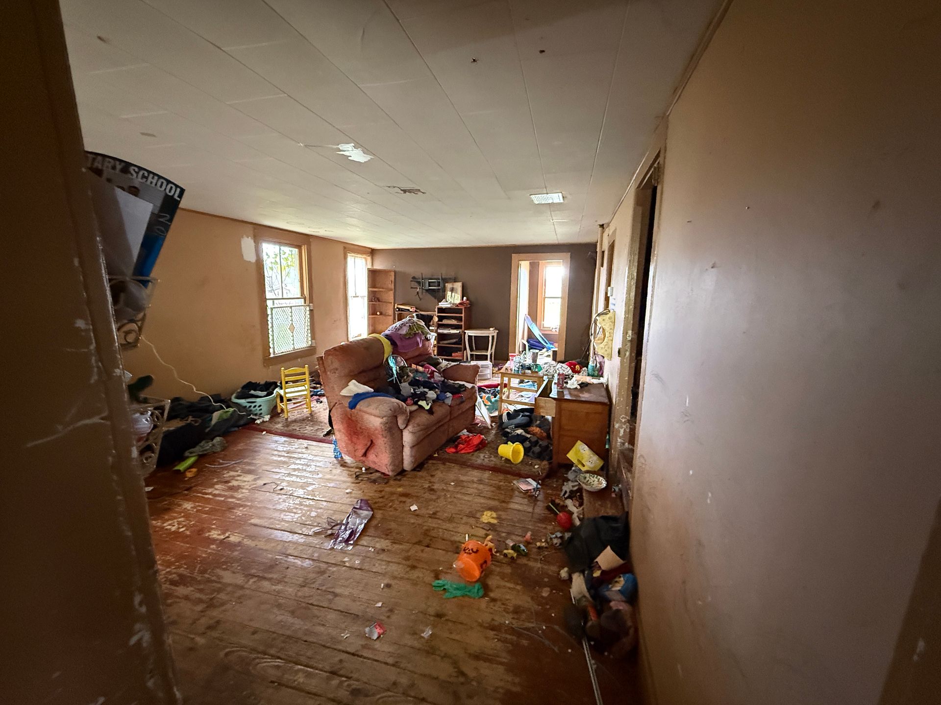 Room with tan walls and wood flooring.