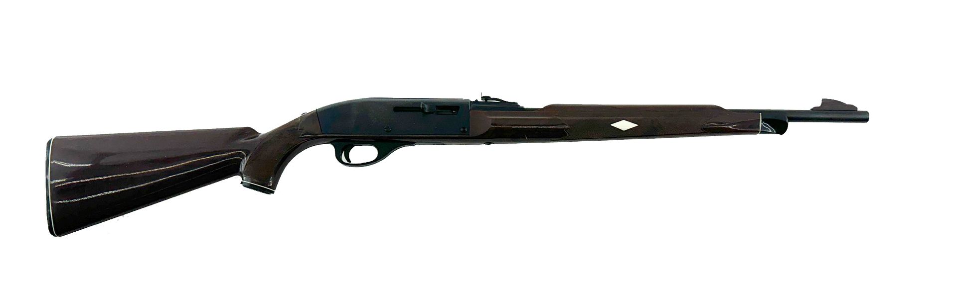 A dark, wood-stocked shotgun with a white cross emblem on the side, against a white background.