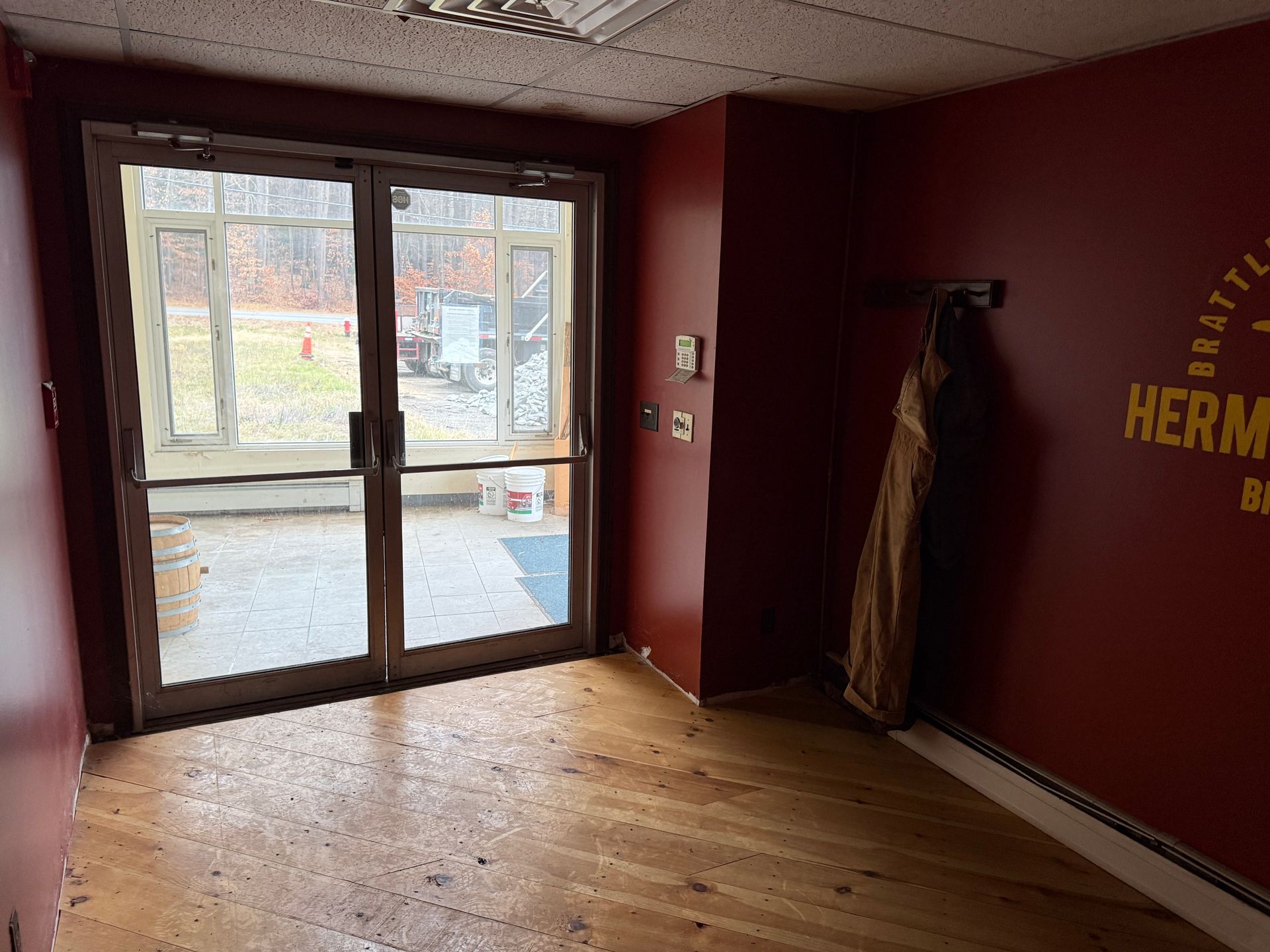 Interior entryway with double glass doors leading outside.