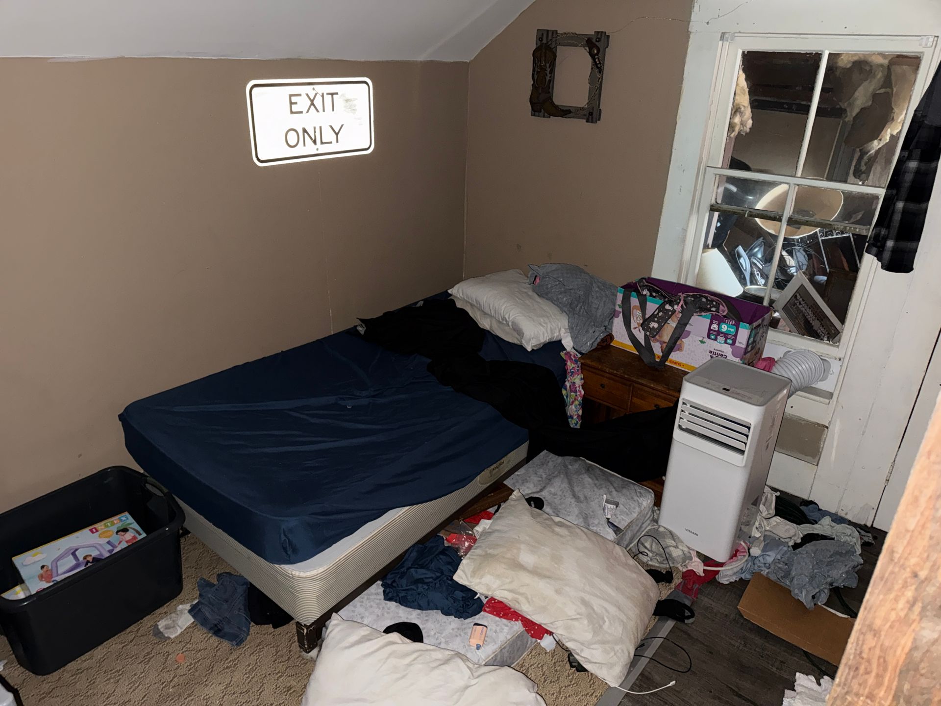 Small bedroom with bed, window, and 