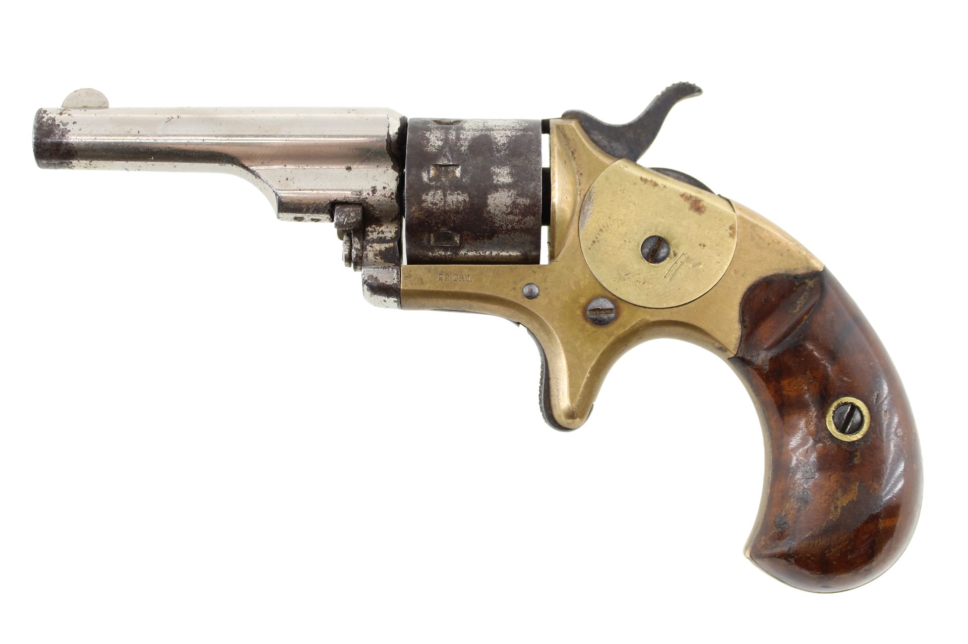 Old brass and steel revolver with wooden grip on a white background