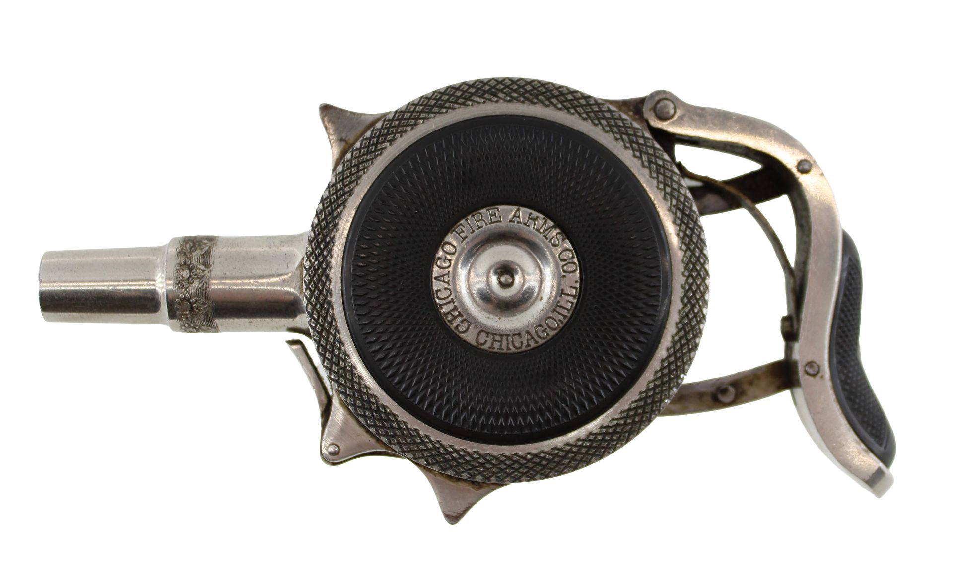 Close-up of a black and silver handgun with a circular wheel and hand grip on a white background