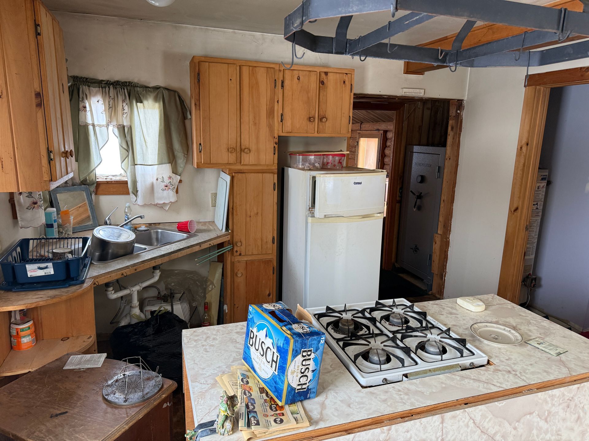 Kitchen with countertops, wooden cabinets, and a gas stove.