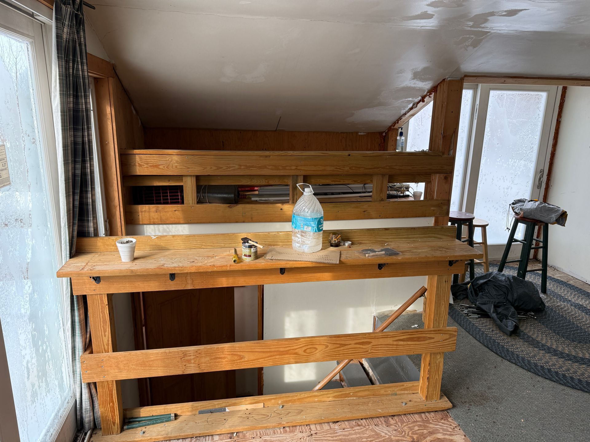 Wooden workbench in a room with a large window.