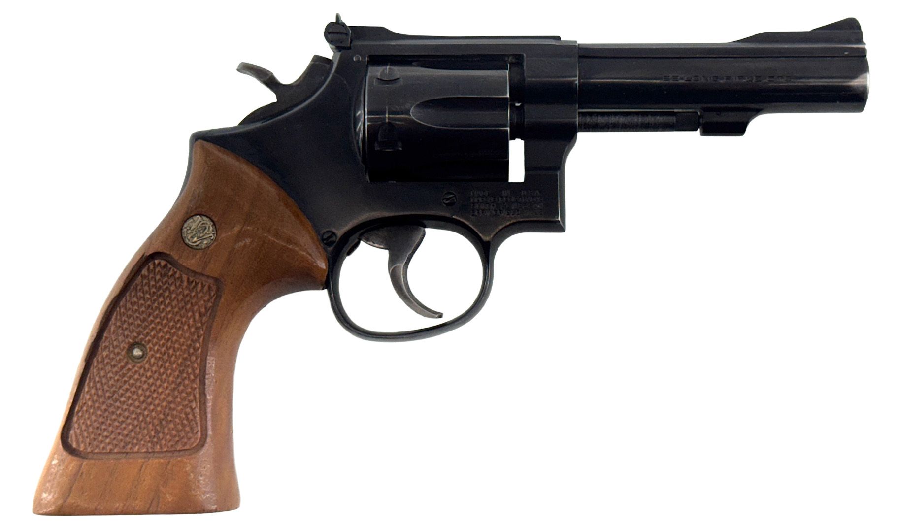 Black revolver with wooden grip, barrel pointing right.