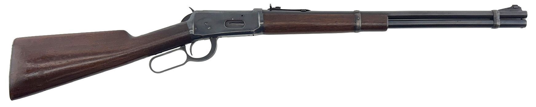 A lever-action rifle, brown wood, black barrel and receiver, resting on a white surface.