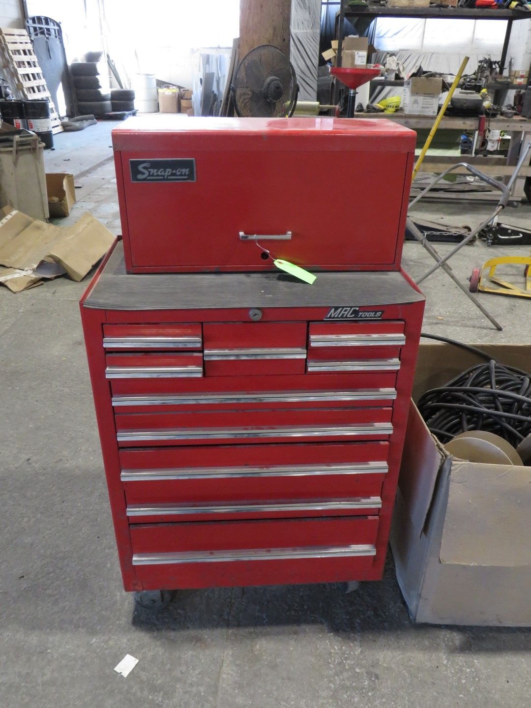 Red tool chest and toolbox stacked in a workshop.