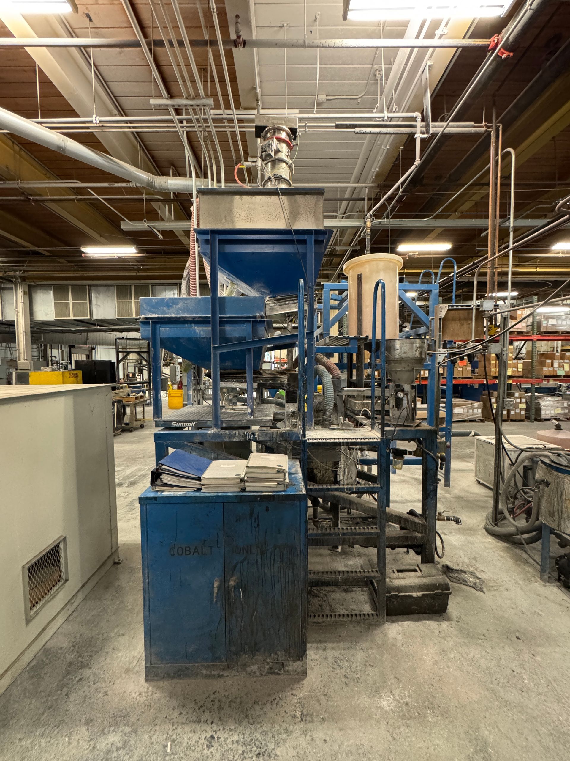Blue industrial machinery in a factory setting.