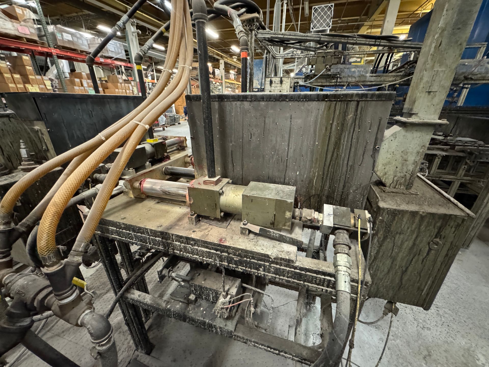 Industrial machinery with pipes and a large container, likely for manufacturing.