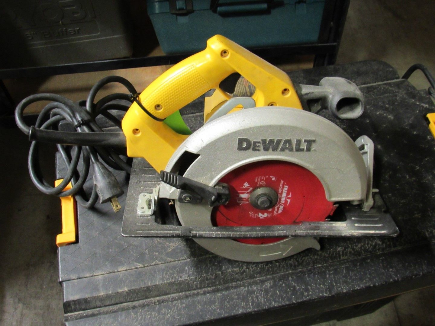 Yellow and silver DeWalt circular saw on a black surface.