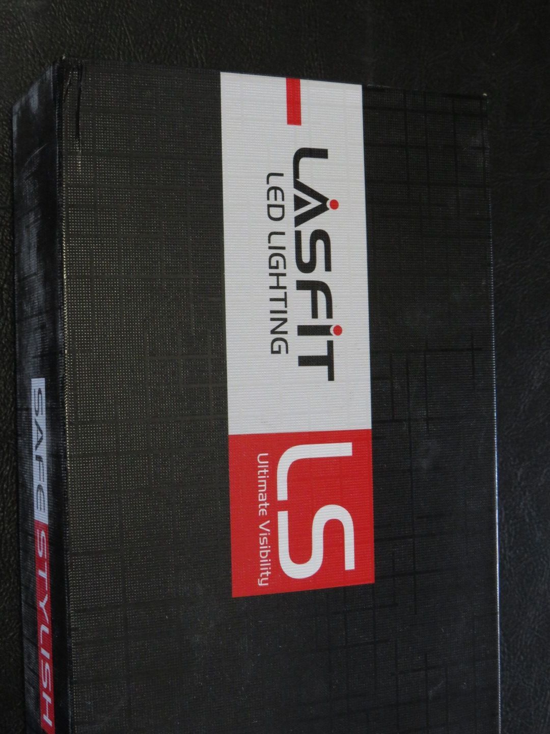 Black box with white and red label reading 