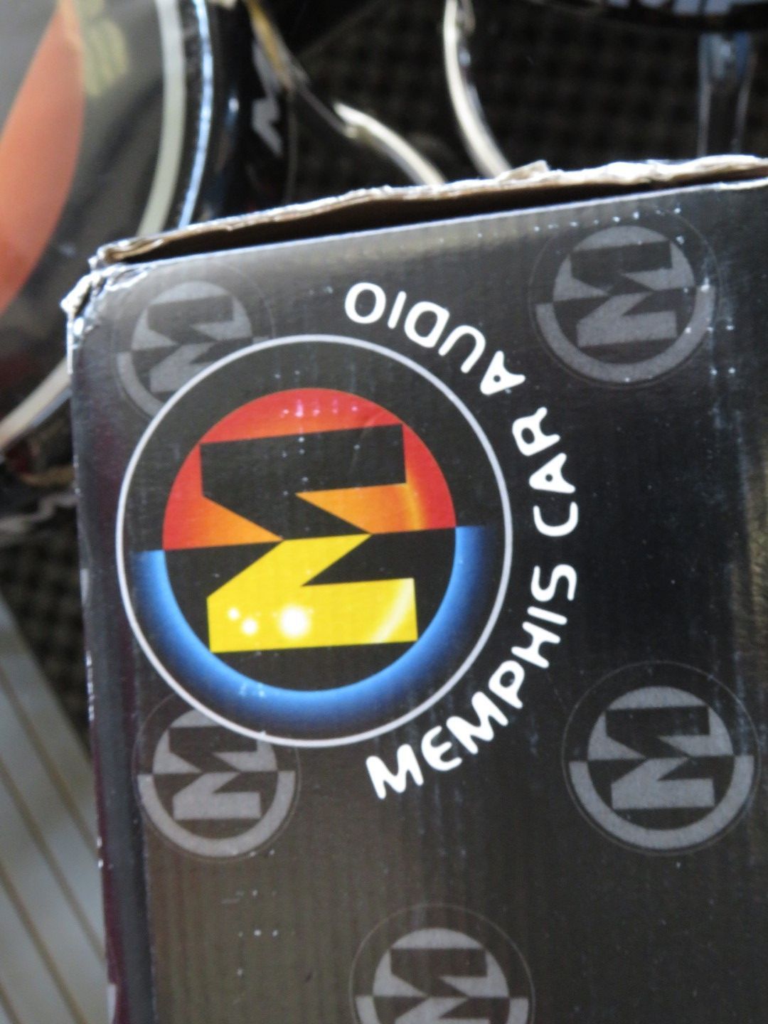 Memphis Car Audio logo on a black box: a stylized 